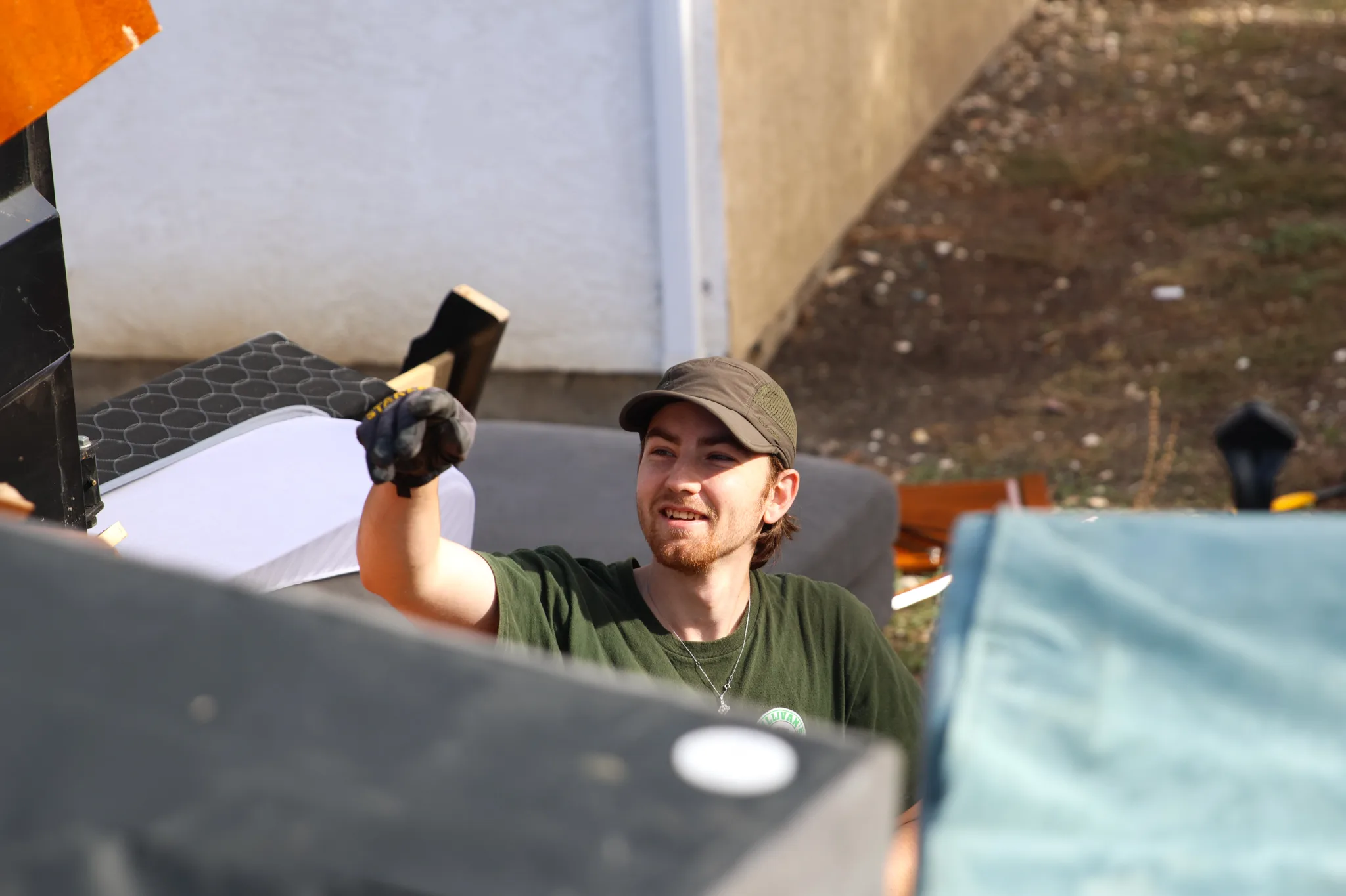 A Sullivan's Hauling crew member smiling while loading furniture on a job
